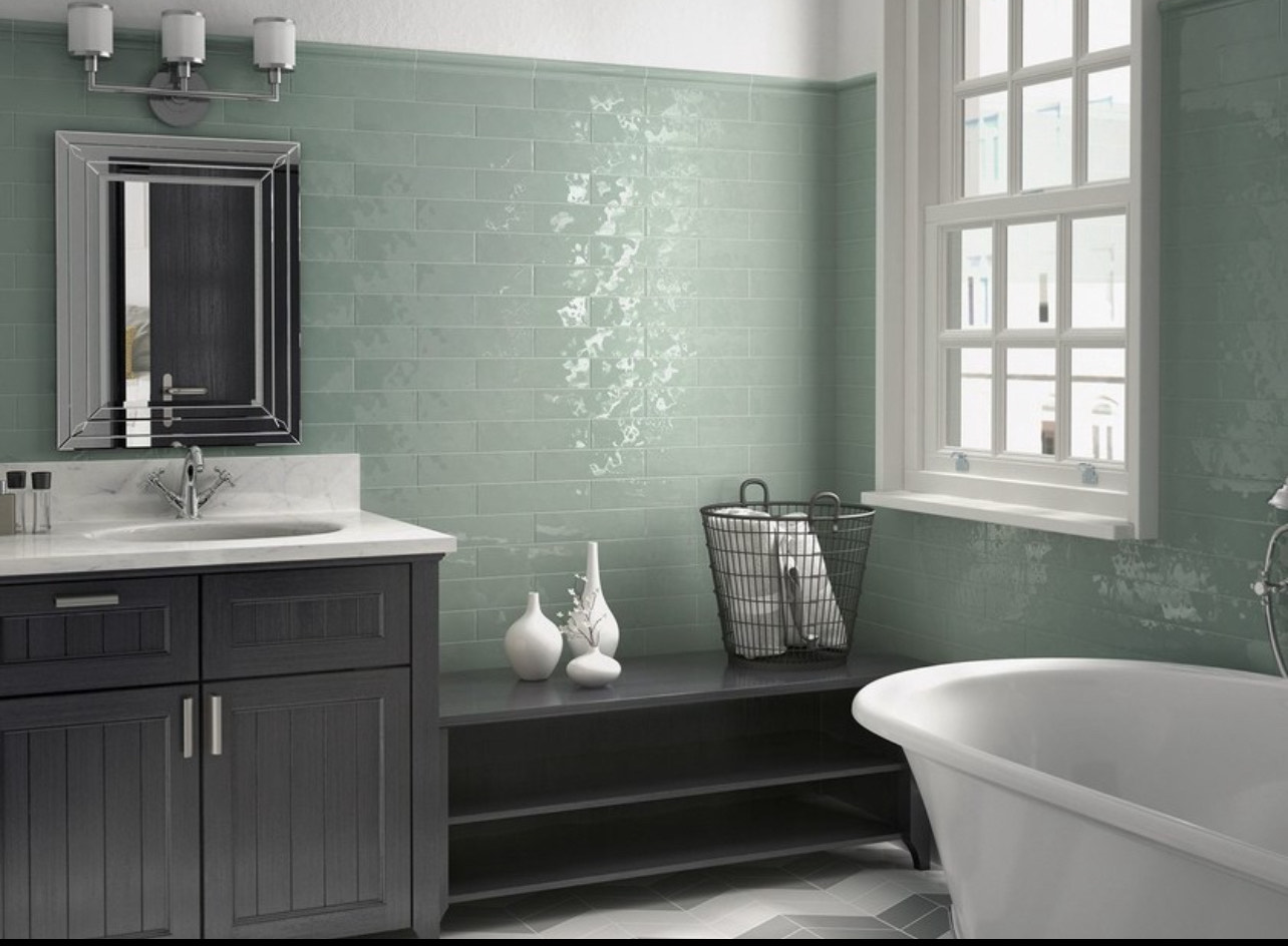 Sage green glazed subway tile bathroom with freestanding tub and dark vanity, Ottawa
